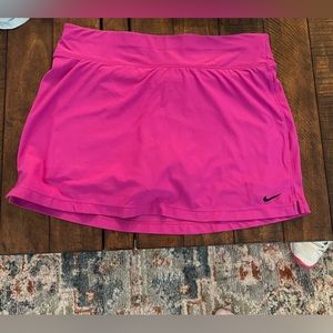 Nike tennis skirt size small. It’s more of a purply pink. Great condition